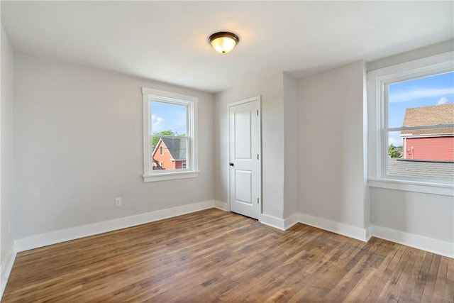 empty room with dark hardwood / wood-style floors