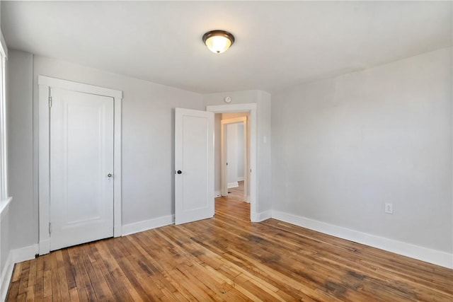 unfurnished bedroom featuring hardwood / wood-style floors and a closet