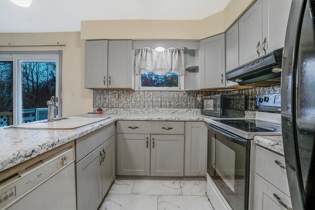 kitchen featuring backsplash, gray cabinets, light stone countertops, sink, and white appliances