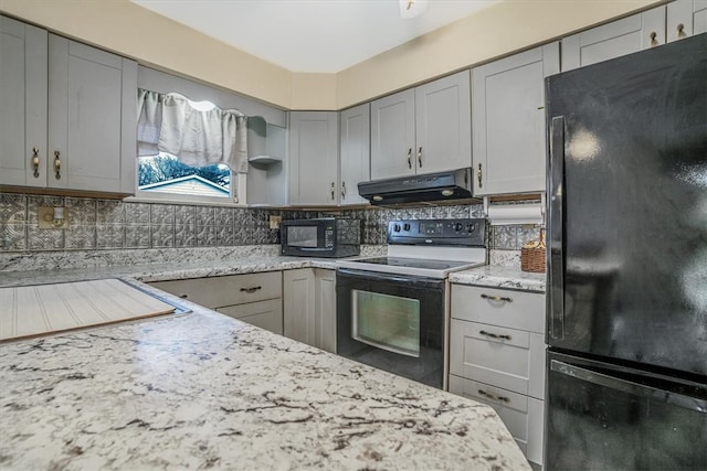 kitchen with gray cabinets, decorative backsplash, black appliances, and light stone counters