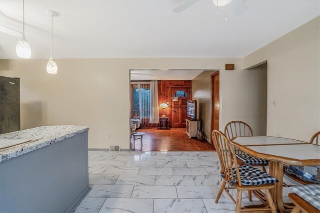 dining room with hardwood / wood-style flooring and ceiling fan