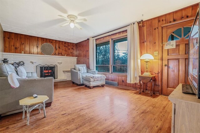 living area featuring wooden walls and light hardwood / wood-style flooring