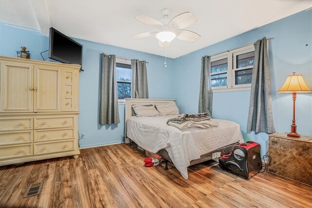 bedroom with light hardwood / wood-style flooring and ceiling fan