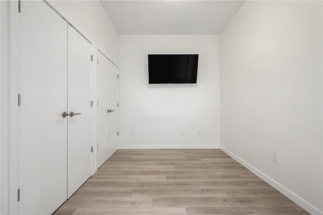 unfurnished bedroom with light wood-type flooring