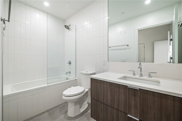 full bathroom featuring tile patterned flooring, vanity, tiled shower / bath combo, and toilet