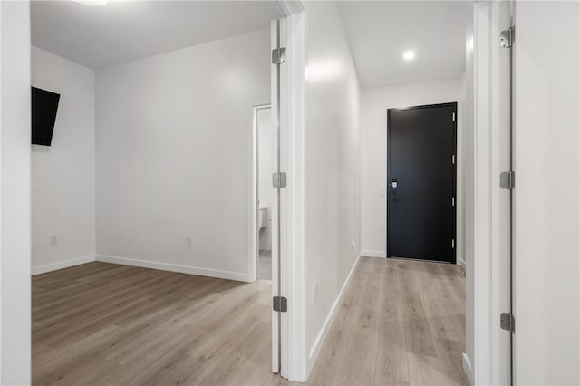 corridor featuring light hardwood / wood-style floors