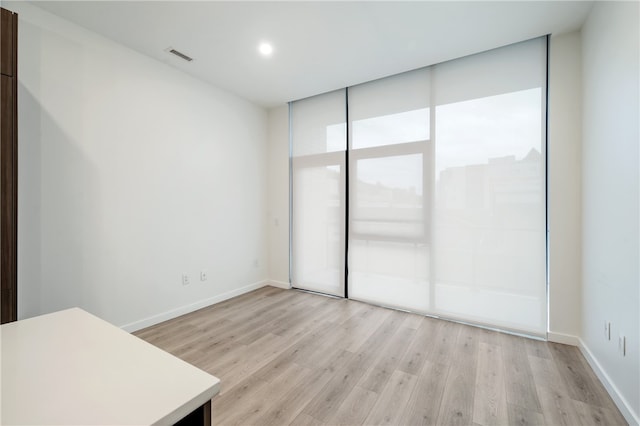 spare room featuring light hardwood / wood-style flooring