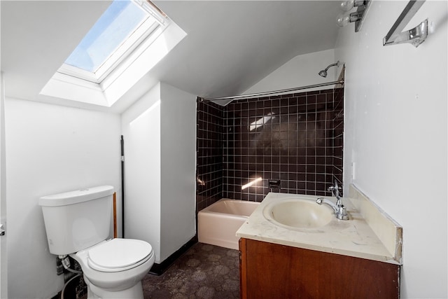 full bathroom with vanity, vaulted ceiling with skylight, tiled shower / bath, and toilet