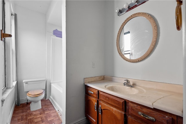 bathroom featuring vanity, parquet flooring, and toilet