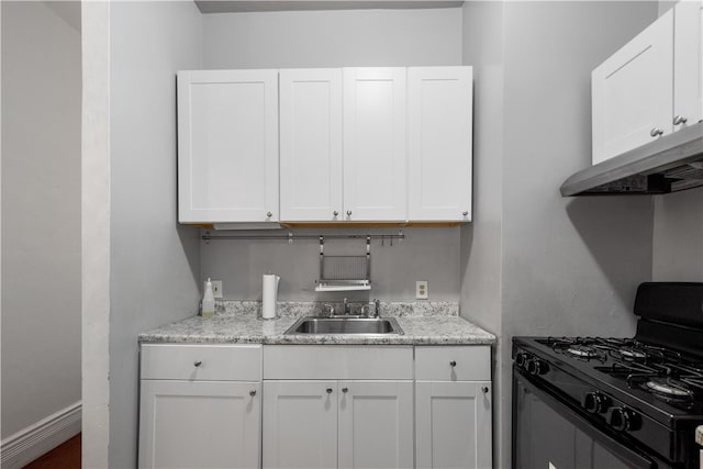 kitchen featuring white cabinetry, black range with gas cooktop, sink, and light stone countertops