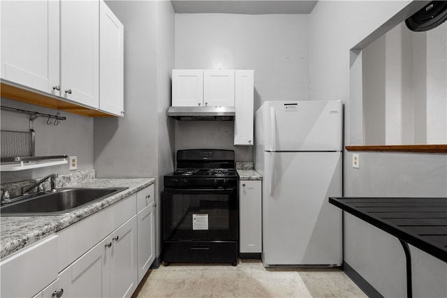 kitchen featuring sink, gas stove, light stone countertops, white cabinets, and white refrigerator