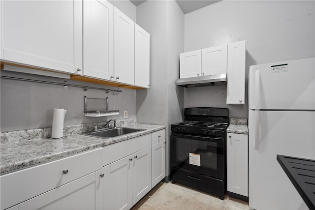 kitchen with white cabinets, white fridge, black gas range, and sink