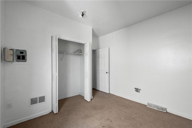 unfurnished bedroom with carpet and a closet