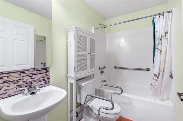 bathroom with shower / bath combination with curtain, sink, and tasteful backsplash