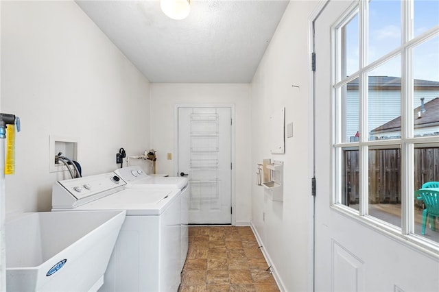 washroom featuring washer and clothes dryer, a wealth of natural light, sink, and a textured ceiling