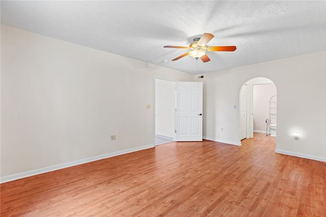 unfurnished room featuring a textured ceiling, ceiling fan, and light hardwood / wood-style flooring