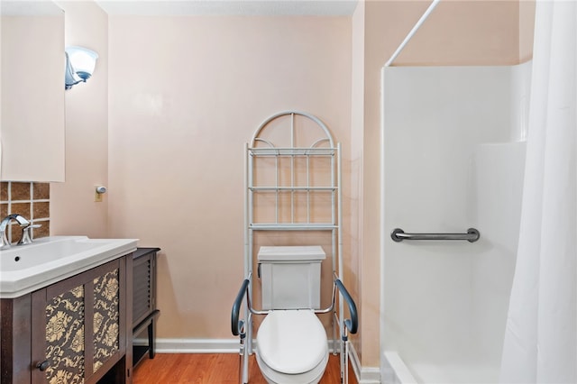 bathroom with wood-type flooring, vanity, toilet, and decorative backsplash