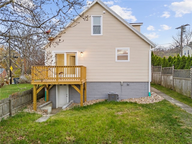 back of house featuring cooling unit, a yard, and a deck