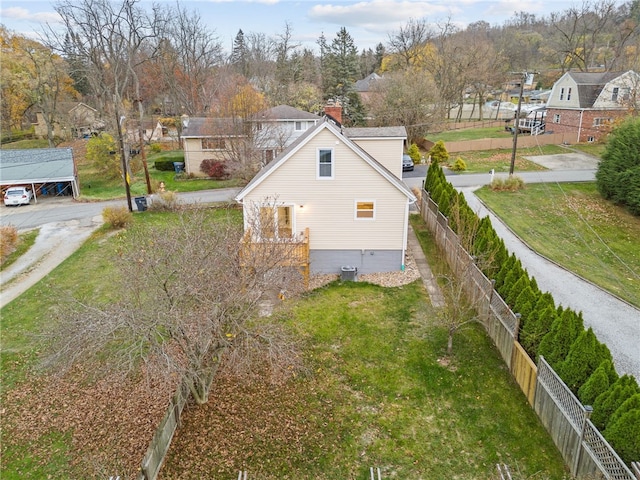 view of side of home featuring central AC unit and a lawn