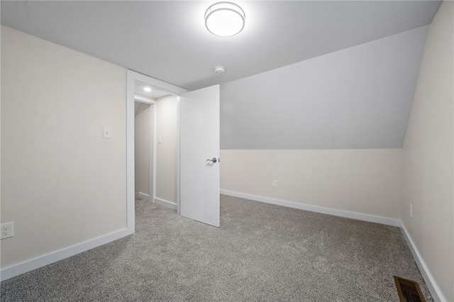 bonus room featuring lofted ceiling and light carpet