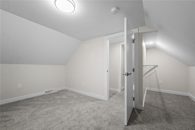 bonus room featuring vaulted ceiling and carpet floors