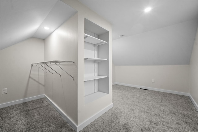 spacious closet featuring vaulted ceiling and carpet