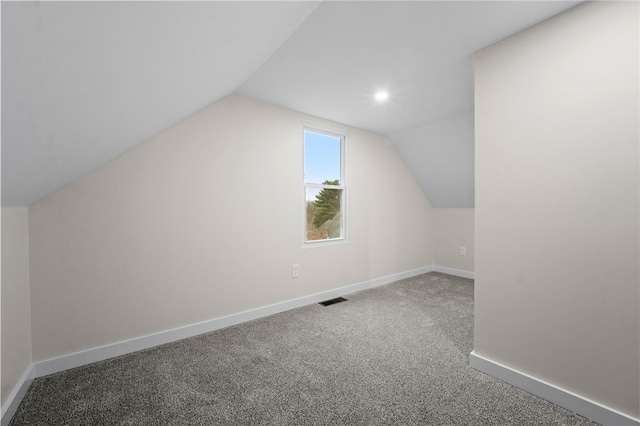 additional living space with lofted ceiling and carpet floors