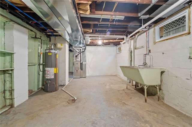 basement with water heater, heating unit, and sink