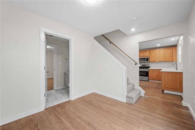 interior space featuring light wood-type flooring and sink