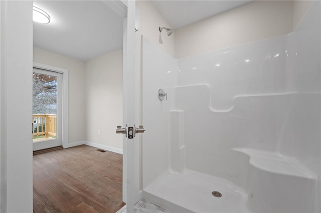 bathroom with wood-type flooring and a shower