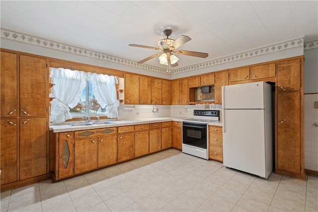 kitchen with tasteful backsplash, white appliances, sink, and ceiling fan