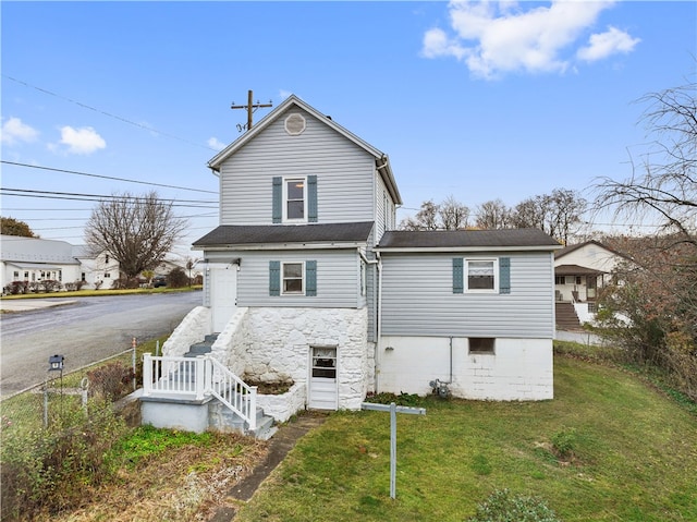 rear view of house with a yard