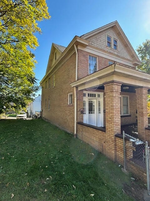 view of property exterior featuring a lawn