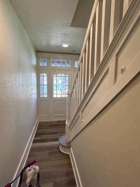 entryway with a textured ceiling and dark hardwood / wood-style floors