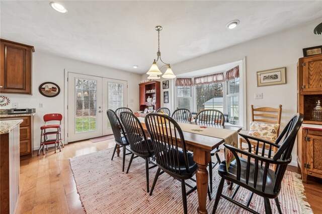 dining room featuring french doors and light hardwood / wood-style flooring