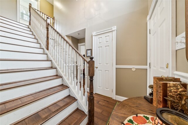 stairs featuring hardwood / wood-style floors