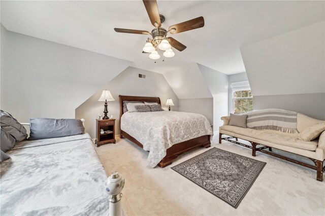 bedroom featuring light colored carpet, lofted ceiling, and ceiling fan