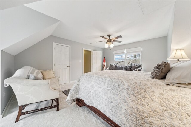 bedroom with ceiling fan, lofted ceiling, and carpet