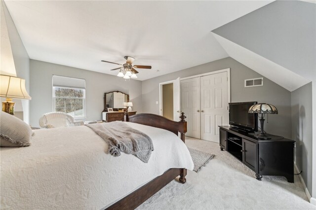 carpeted bedroom featuring lofted ceiling and ceiling fan