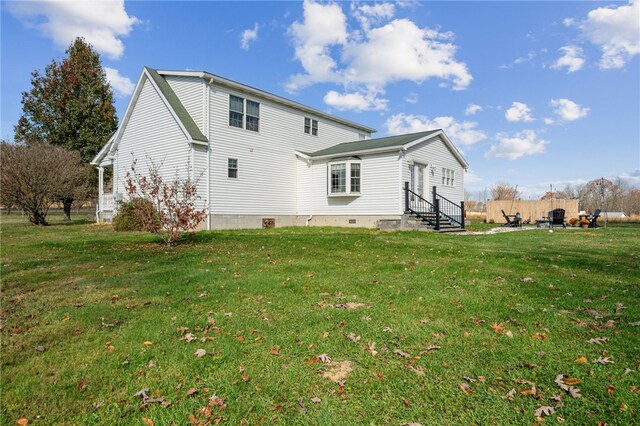 rear view of house featuring a yard