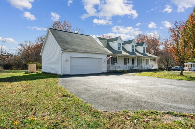 cape cod house with a front lawn, a garage, and covered porch