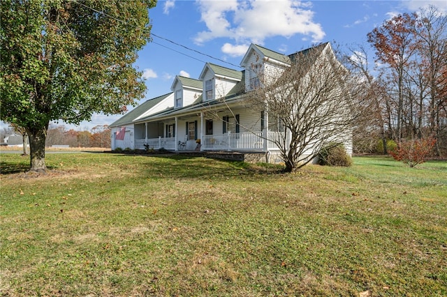 view of side of home with a lawn and covered porch