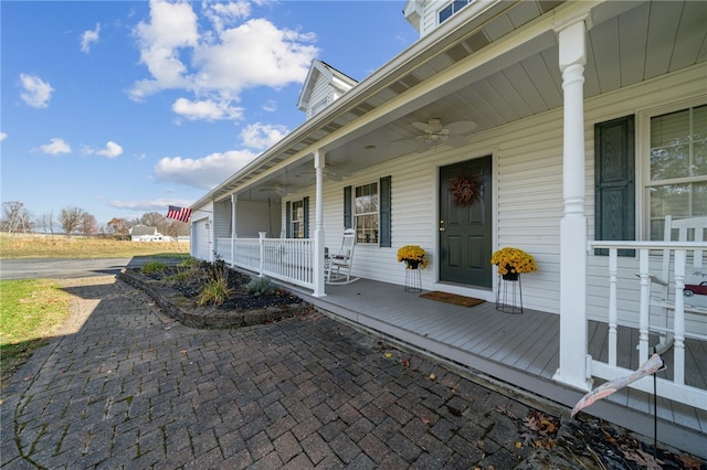 property entrance with a porch and ceiling fan