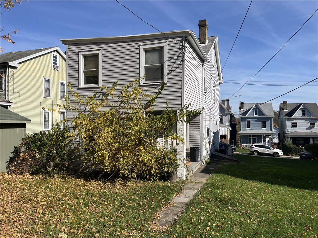 view of property exterior with a lawn