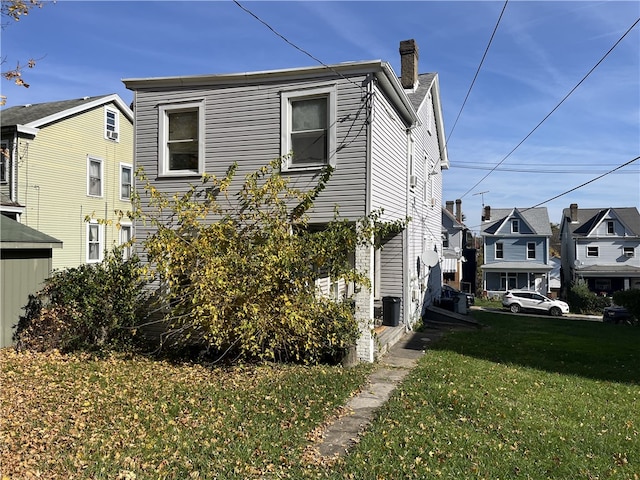 view of property exterior with a lawn