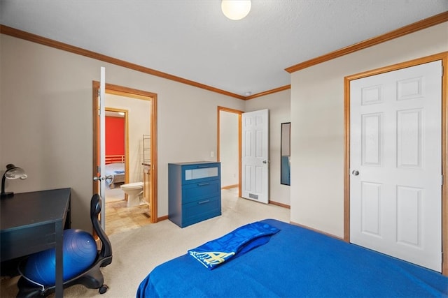 carpeted bedroom with ensuite bath, a textured ceiling, and crown molding