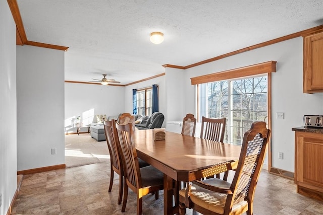 dining space with crown molding, a textured ceiling, and ceiling fan