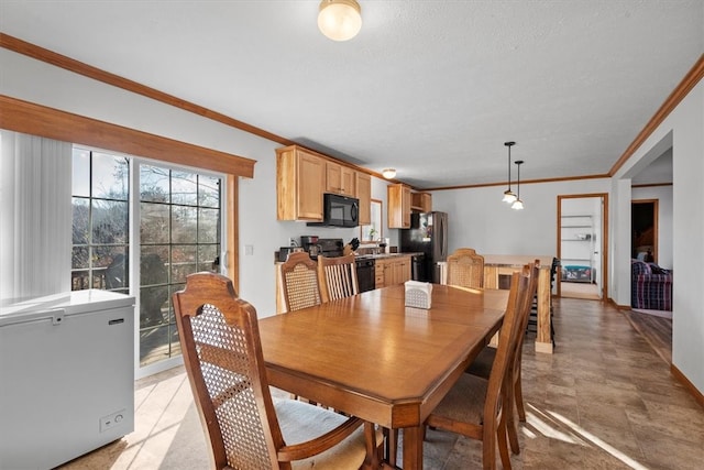 dining area with a textured ceiling and crown molding