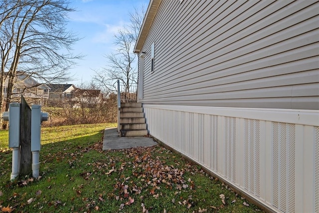 view of home's exterior with a lawn