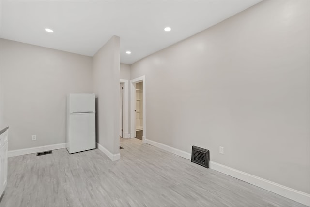 interior space featuring light wood-type flooring and white fridge